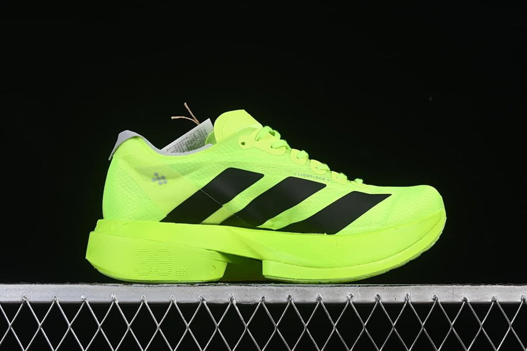 Side profile of lime green shoe with black stripes