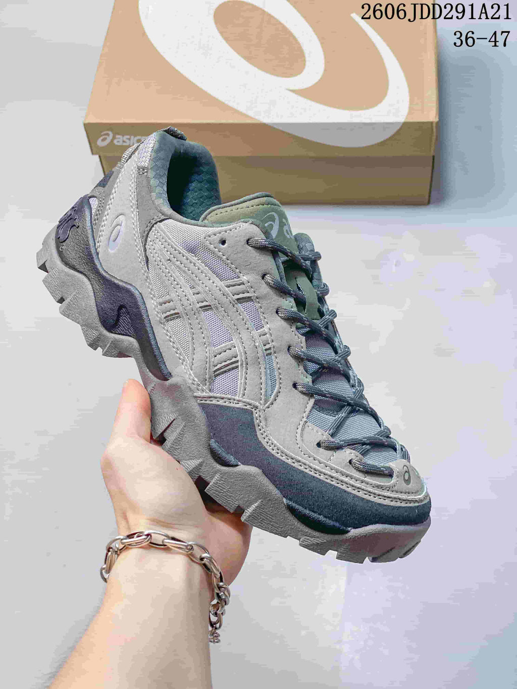 Gray ASICS GEL-PICKAX sneaker with dark laces and a rugged outsole.