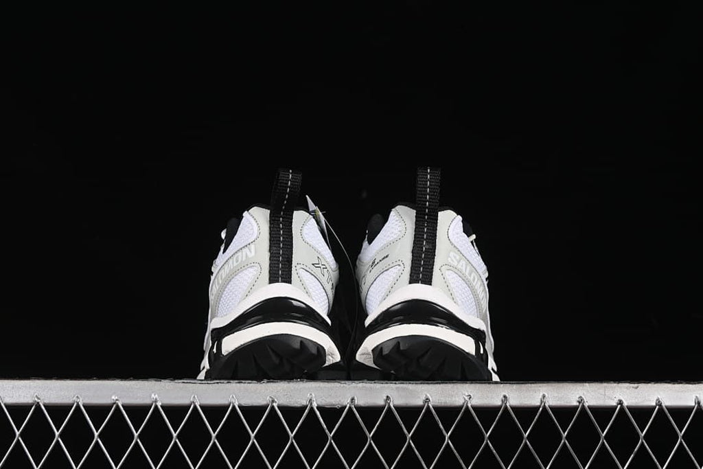 Rear view of both shoes showing heel details and lugged outsole edges.