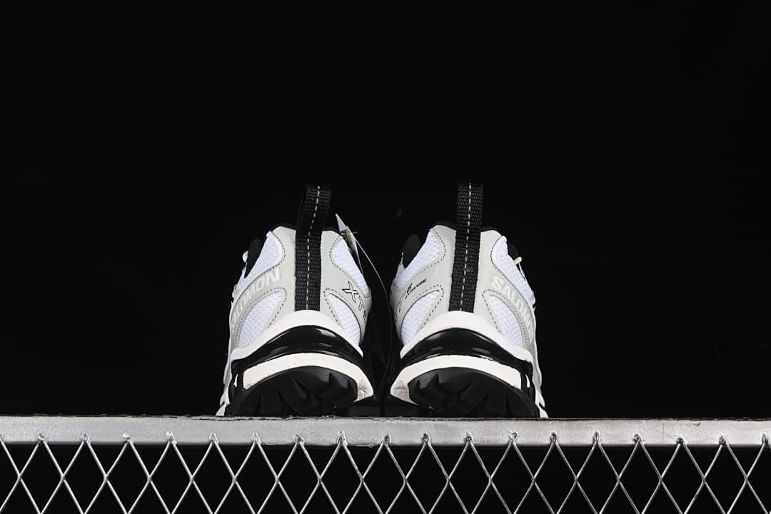 Rear view of both shoes showing heel details and lugged outsole edges.