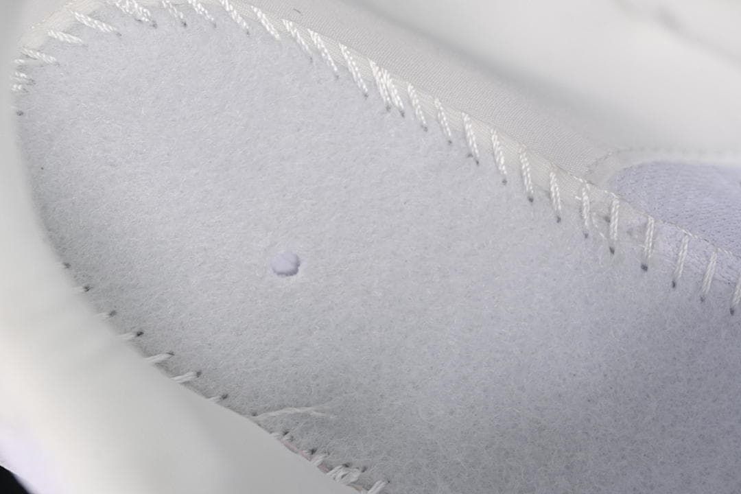 Close-up of stitching and interior material on the white sneaker