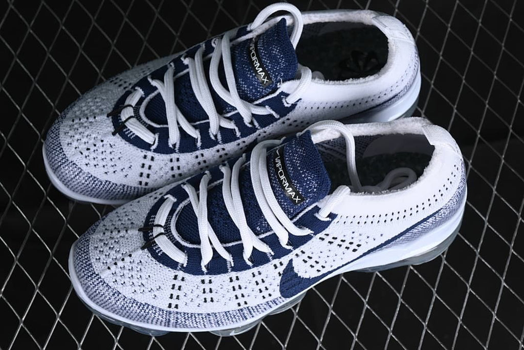 Pair of white and navy Nike Air VaporMax 2023 Flyknit sneakers