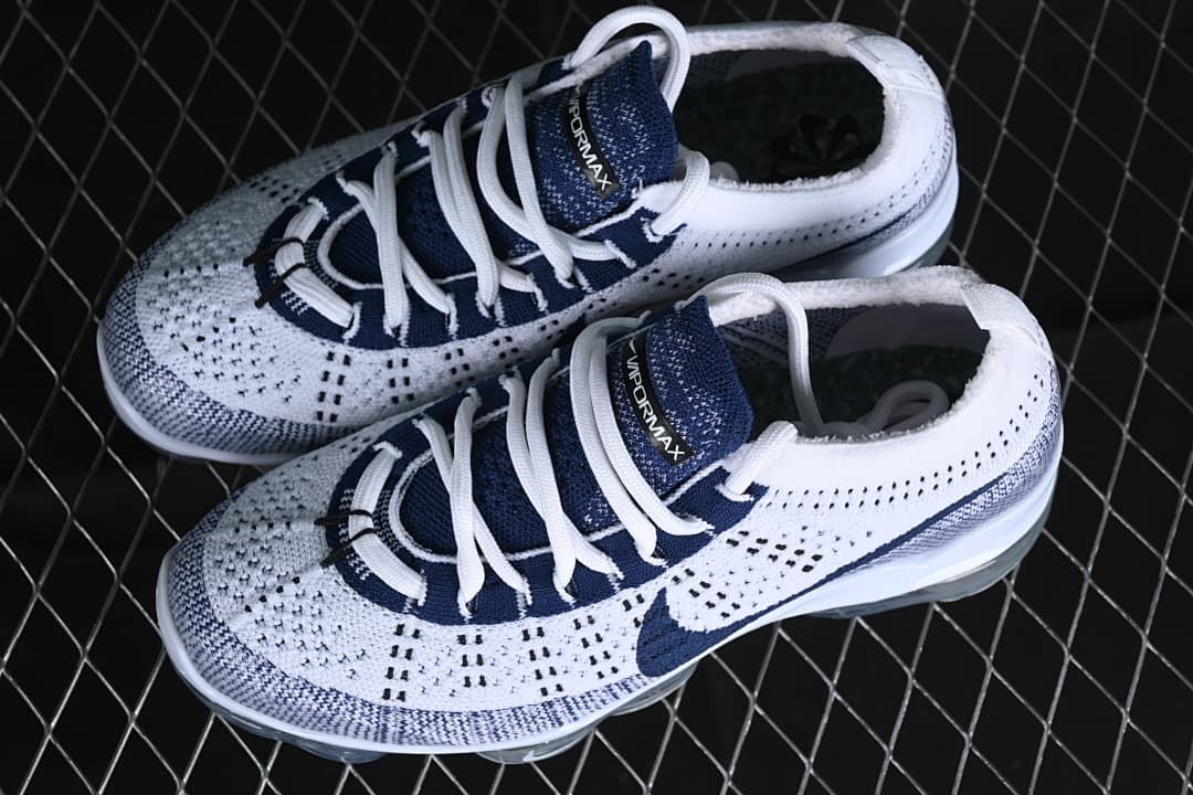 Pair of white and navy Nike Air VaporMax 2023 Flyknit sneakers