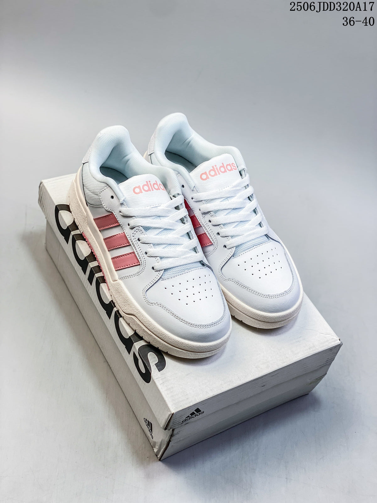 Pair of white adidas Entrap sneakers with pink stripes displayed on a shoebox