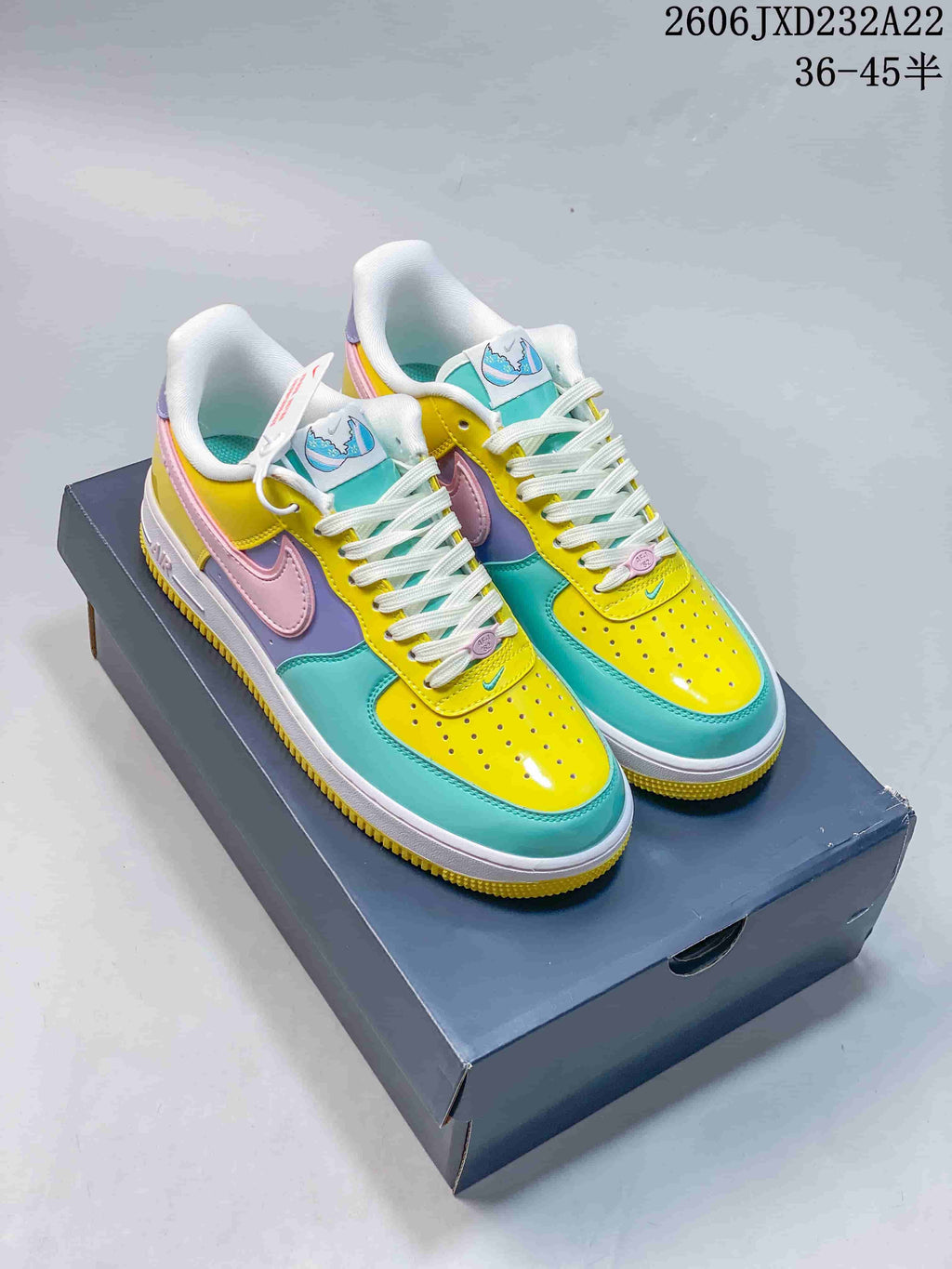 Pair of multicolor Nike Air Force 1 '07 Low style sneakers on a shoebox