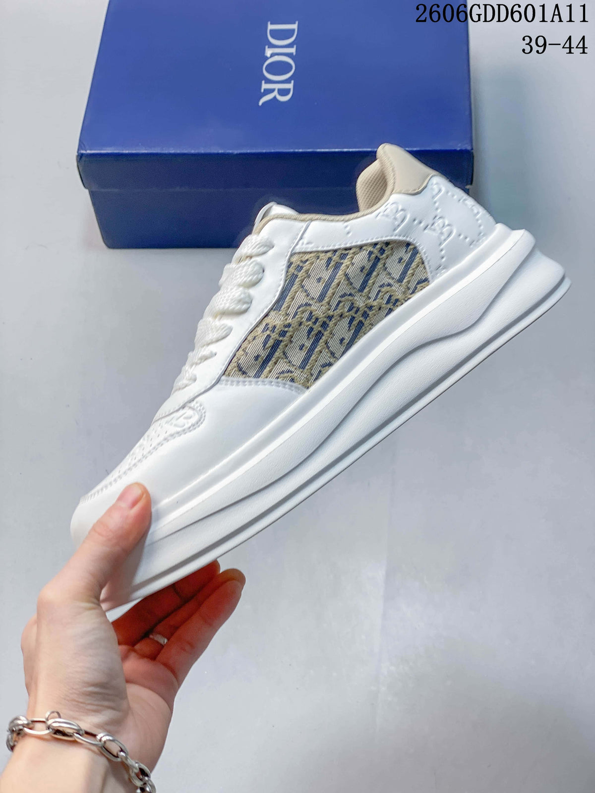 Side profile of a white sneaker with a beige patterned panel and thick sole.