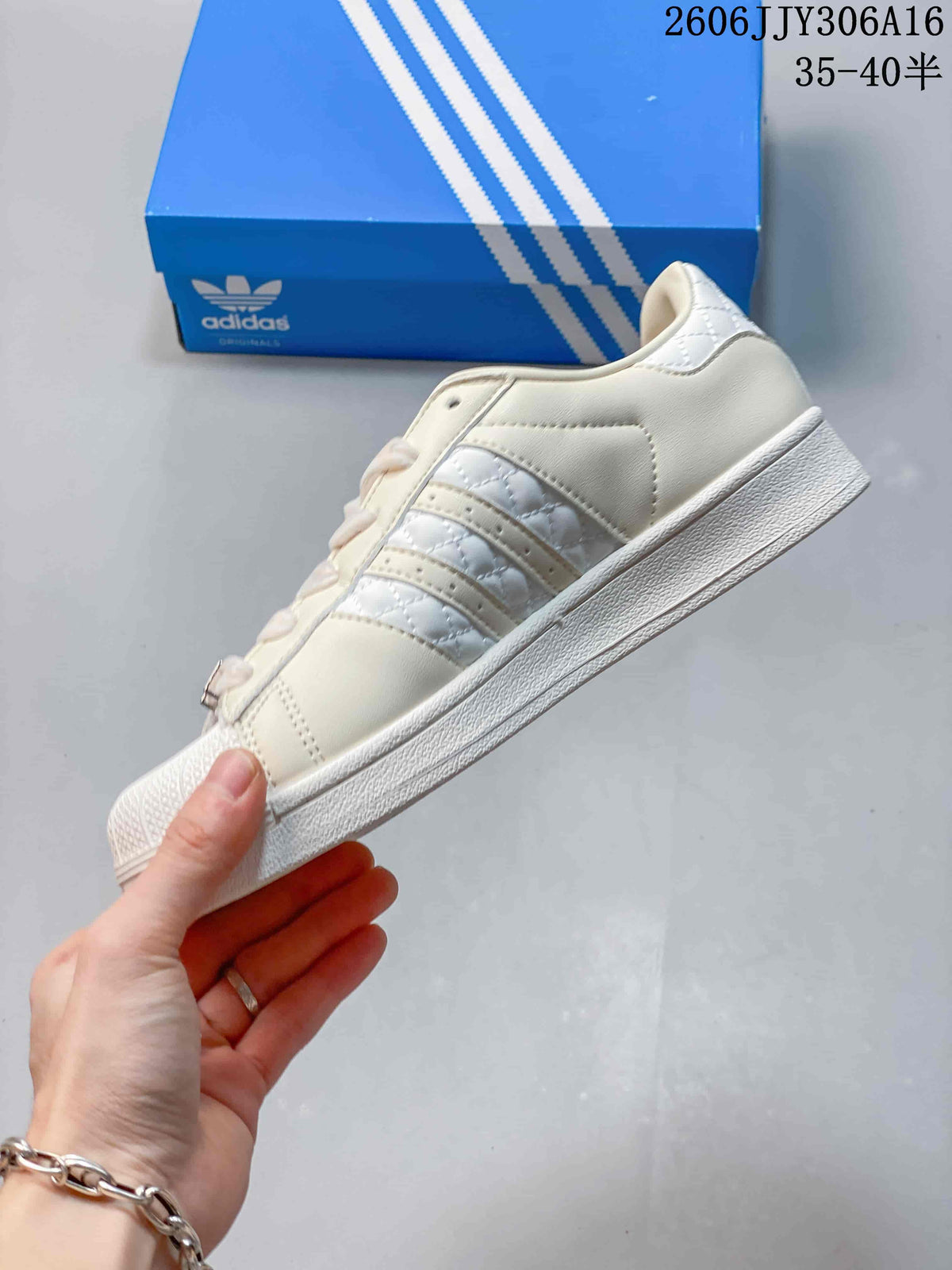 Side profile showing the three stripes, quilted detailing, and shell toe