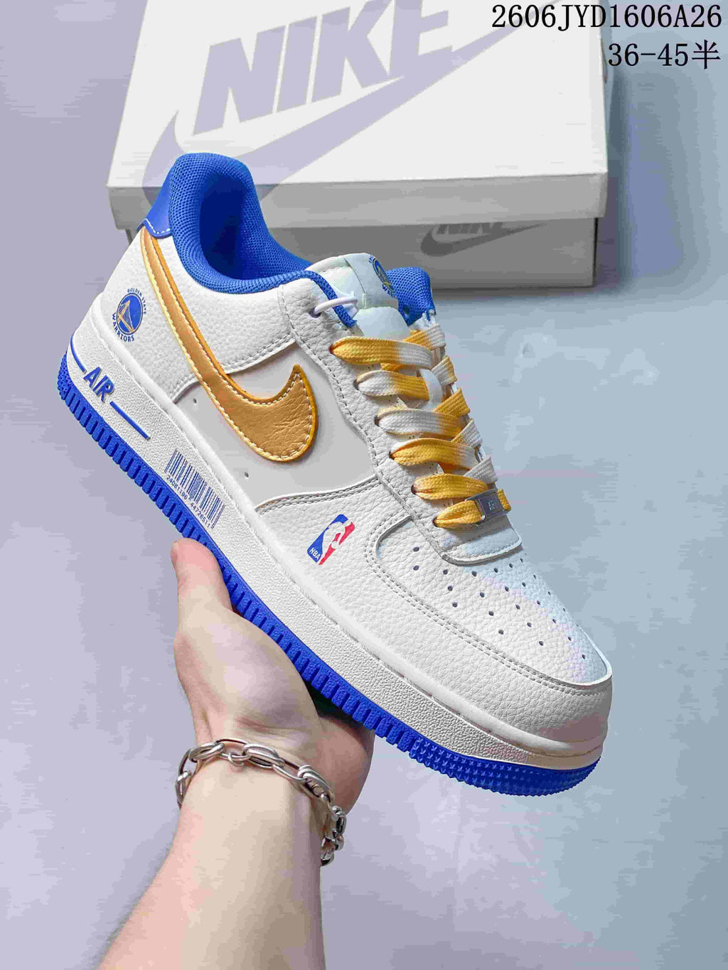 White low-top sneaker with gold Swoosh, blue trim and Golden State Warriors graphics