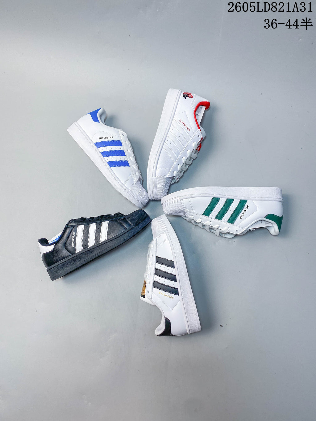 Several adidas Superstar sneakers arranged together, showing different accent colors.