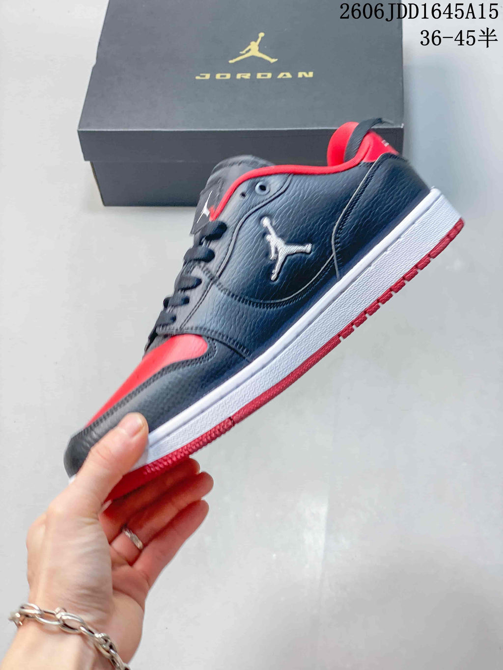 Side view of a navy and red Jordan Court Connect low-top sneaker