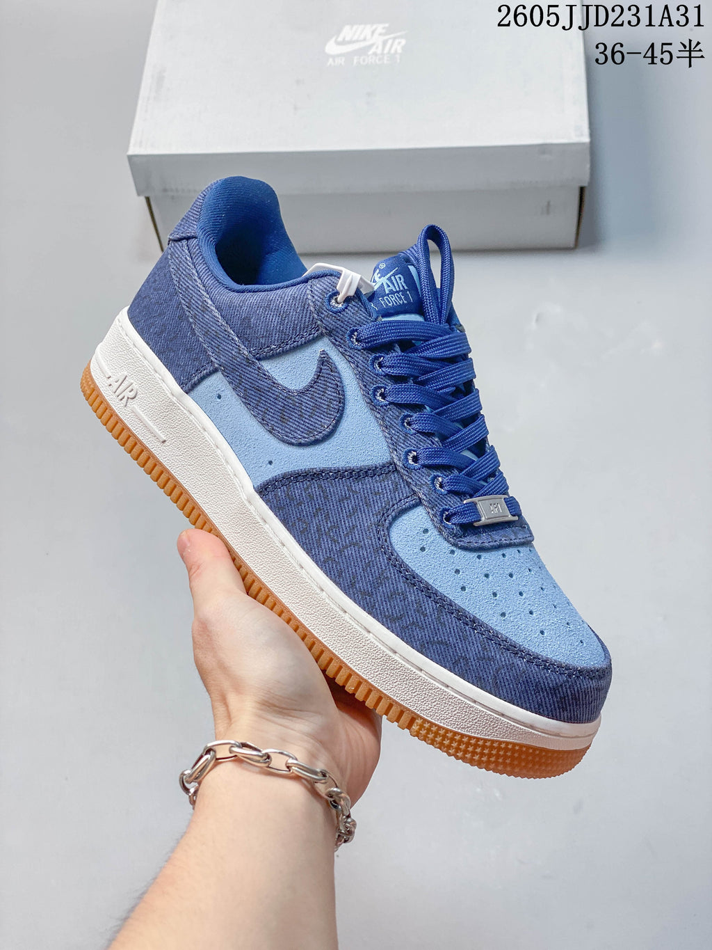 Side view of a blue Nike Air Force 1 Low sneaker with contrasting panels and gum-colored outsole