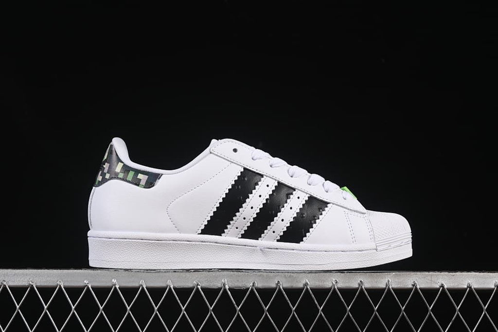 Side profile of the white sneaker with black stripes and a patterned heel