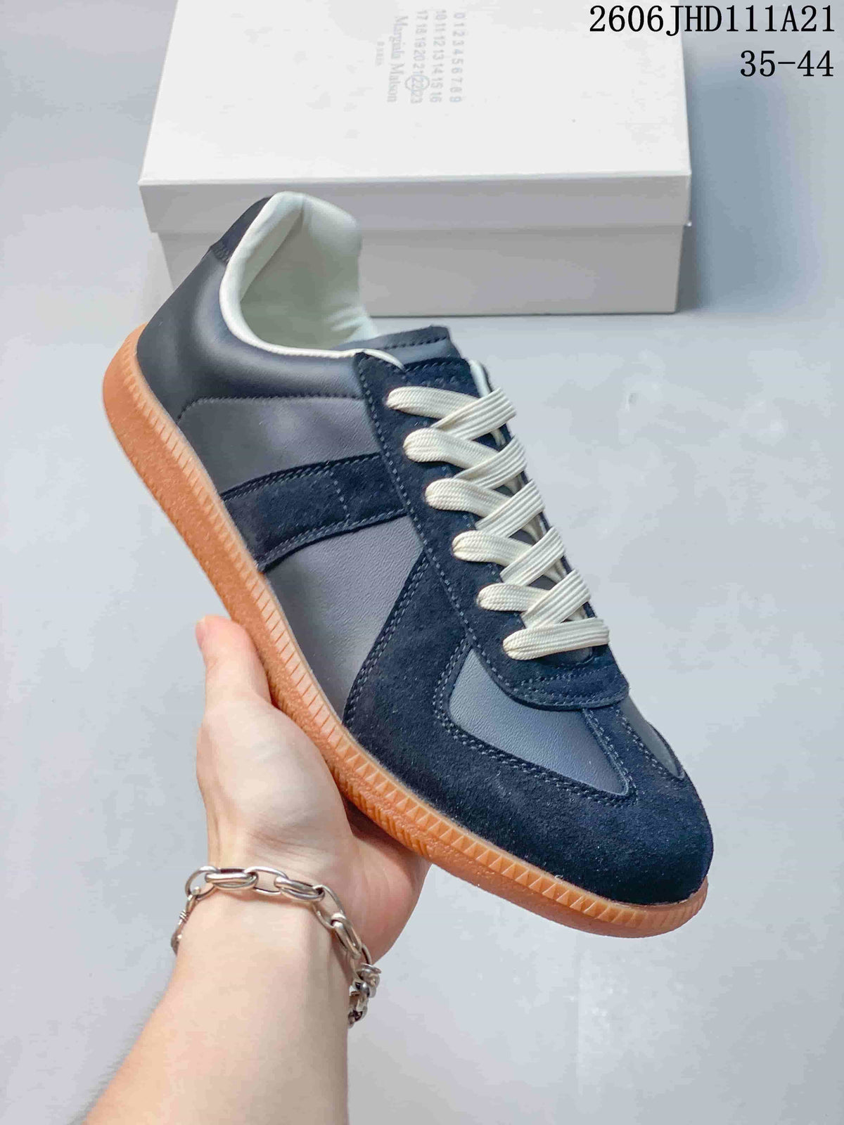 Side view of a navy low-top sneaker with a gum-colored sole