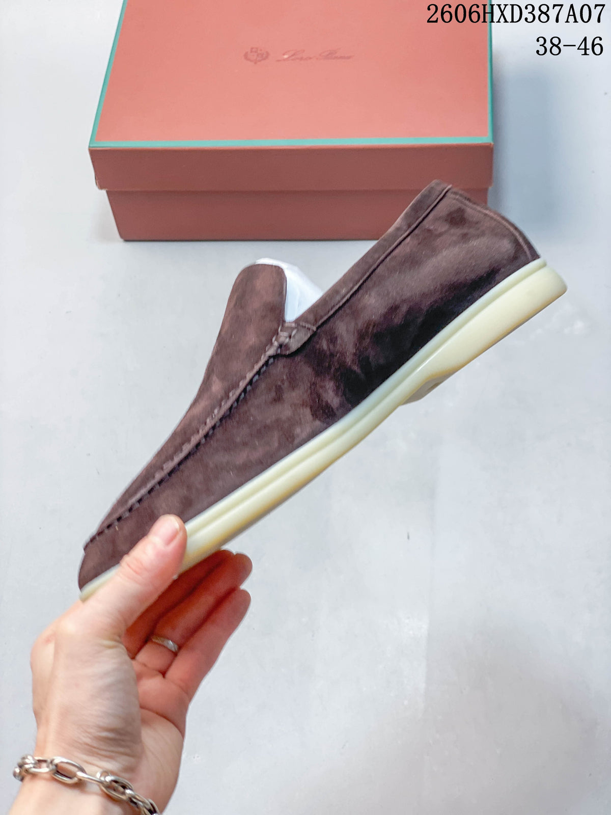 Side profile of a brown-toned loafer with stitched detailing and a light-colored sole.