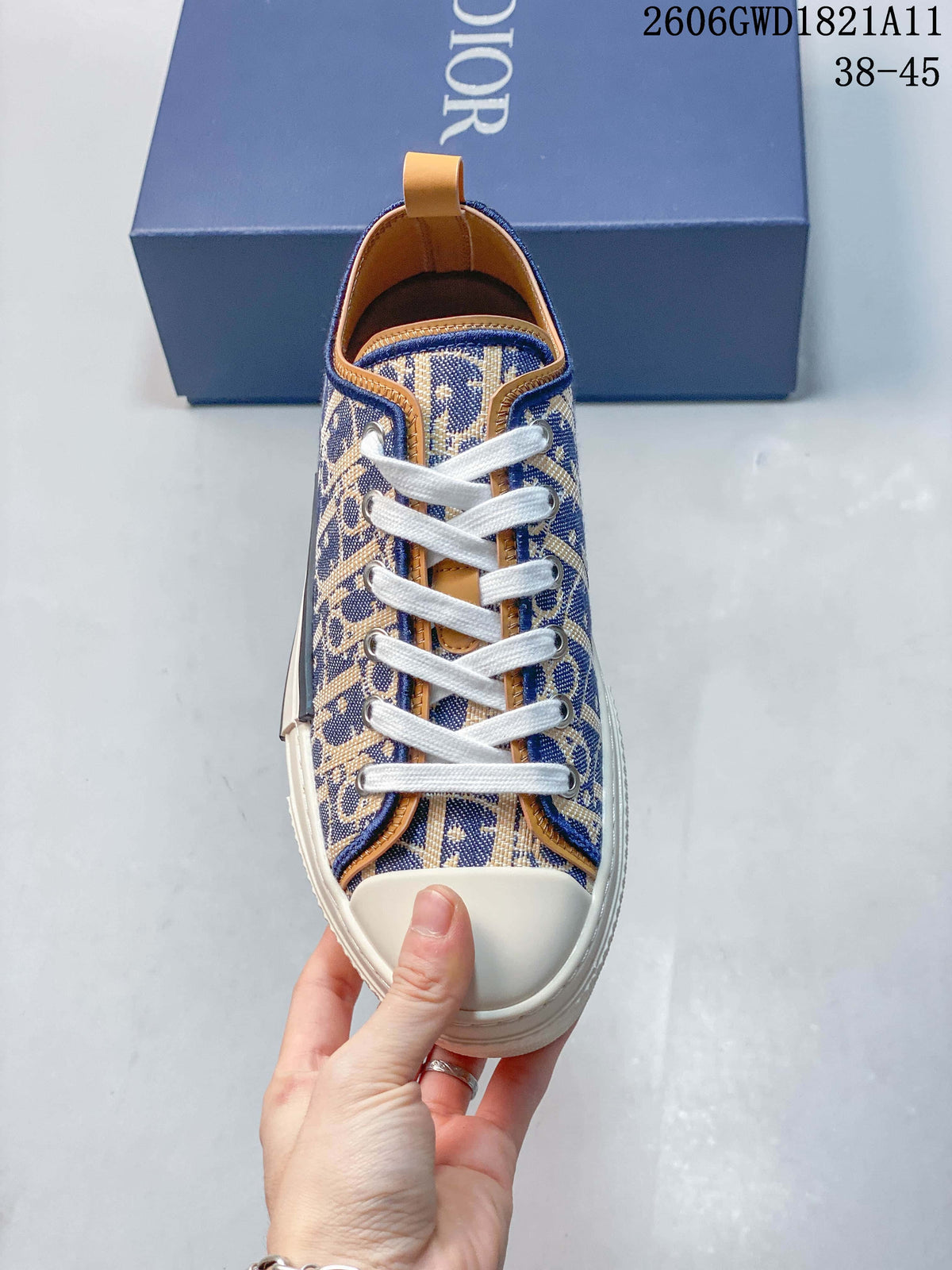 Top view of a patterned low-top sneaker with white laces and cream-colored toe cap