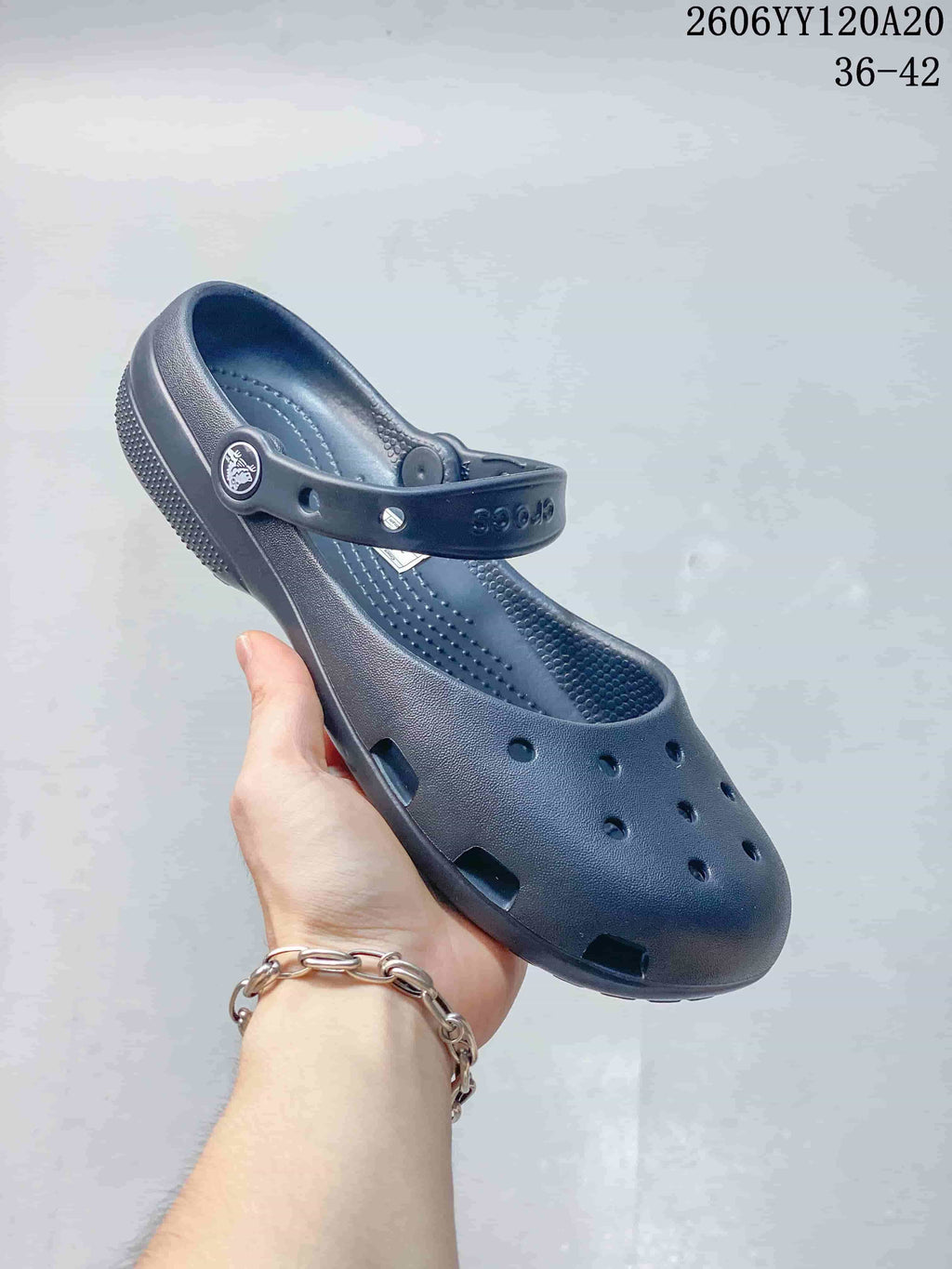 Angled view of a navy clog-style shoe with a pivoting heel strap and ventilation openings; image text shows style code 2606YY120A20 and sizes 36–42.