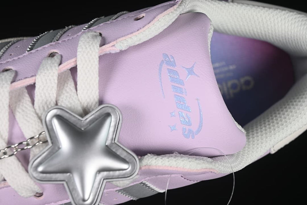 Close-up of the tongue lettering and silver star-shaped lace charm