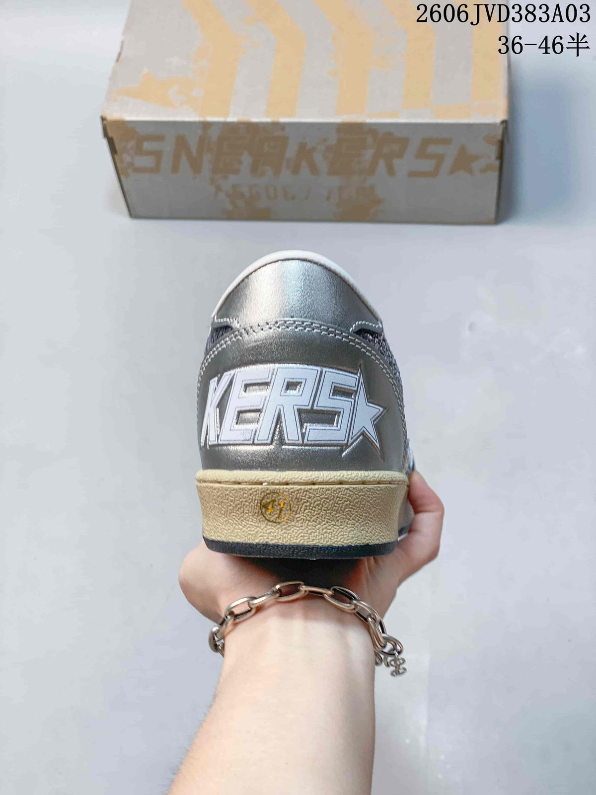 Rear view showing the metallic heel panel and textured midsole