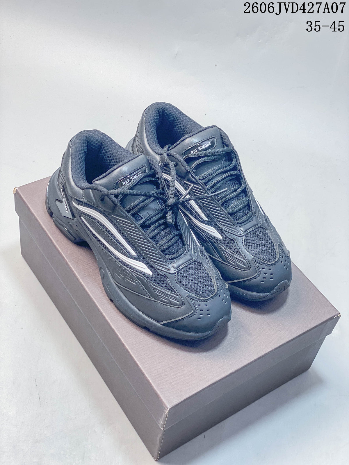 Pair of charcoal Raf Simons Cylon-21 low-top sneakers viewed from above and at an angle