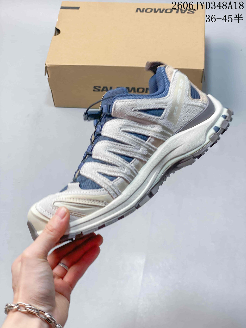Side view showing the layered upper and sole of a Salomon XT-3D shoe
