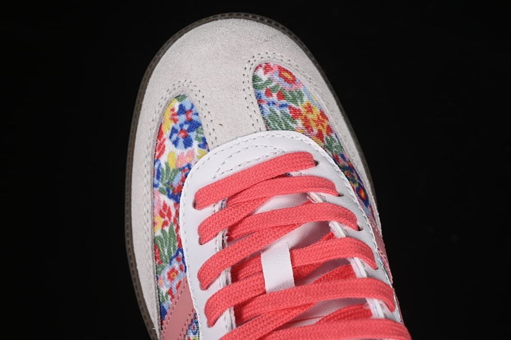 Top view of the toe, floral-print panels, light-colored overlay, and coral laces