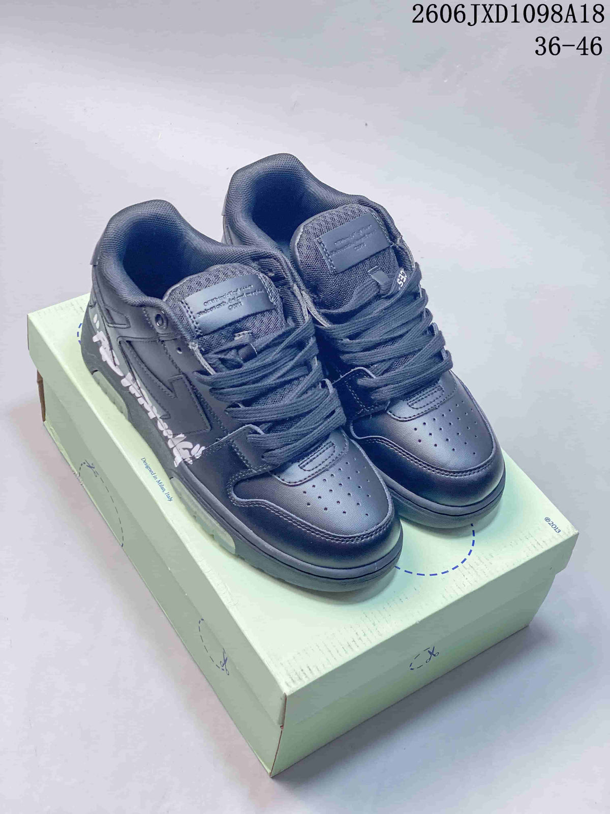 Pair of dark charcoal Off-White Out Of Office-style low-top sneakers on a pale branded box