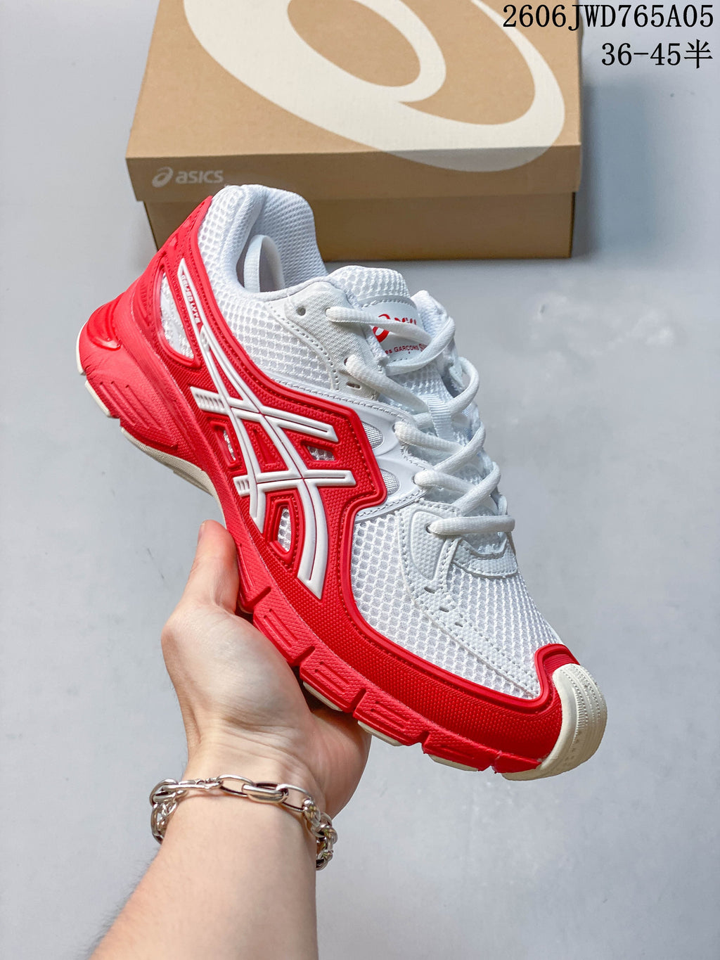 Angled side view of the white and red ASICS Gel-TRUCK sneaker