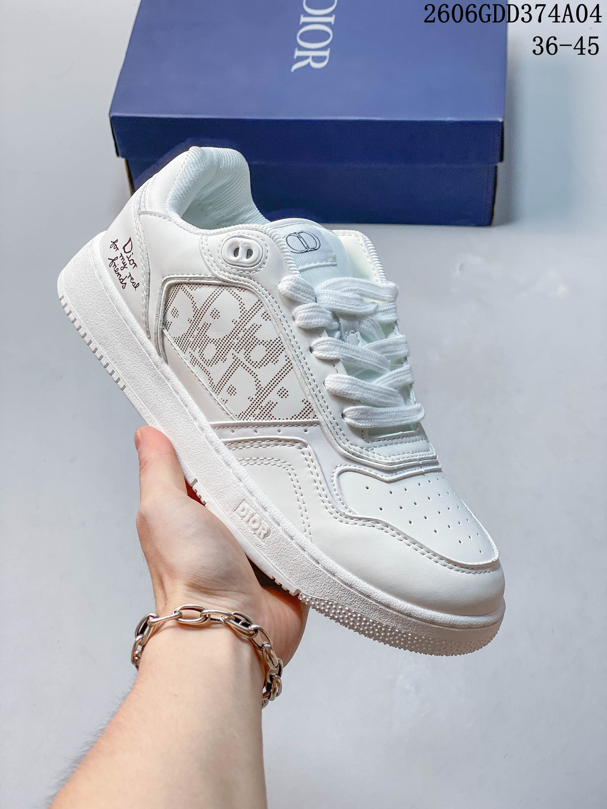 White low-top sneaker with a perforated patterned side panel and white sole.