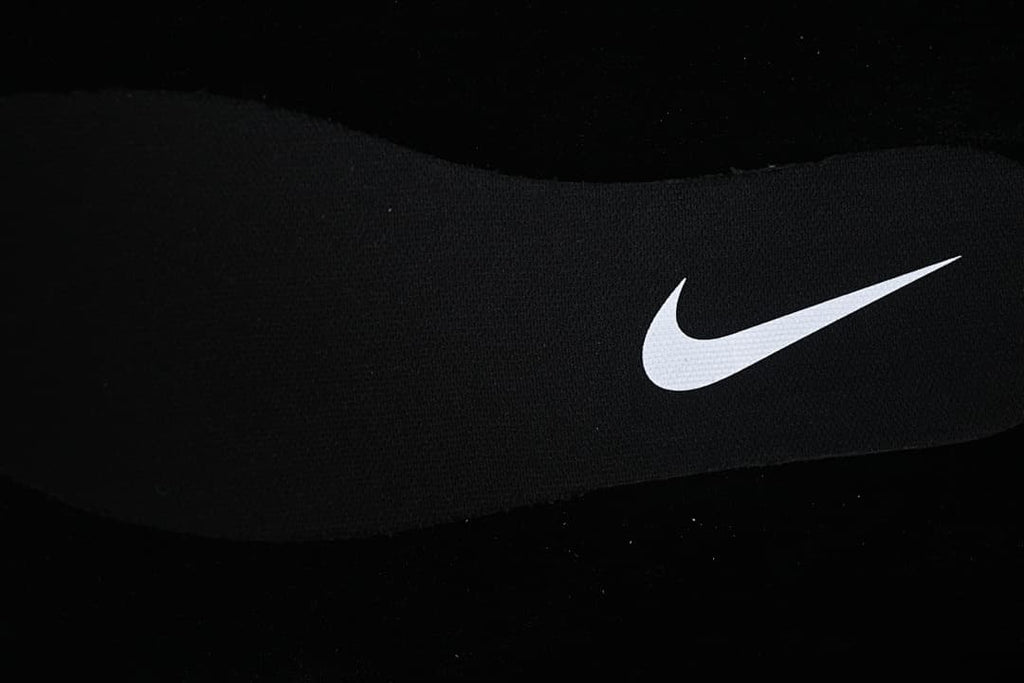 Close-up of the white Swoosh on the black shoe upper.