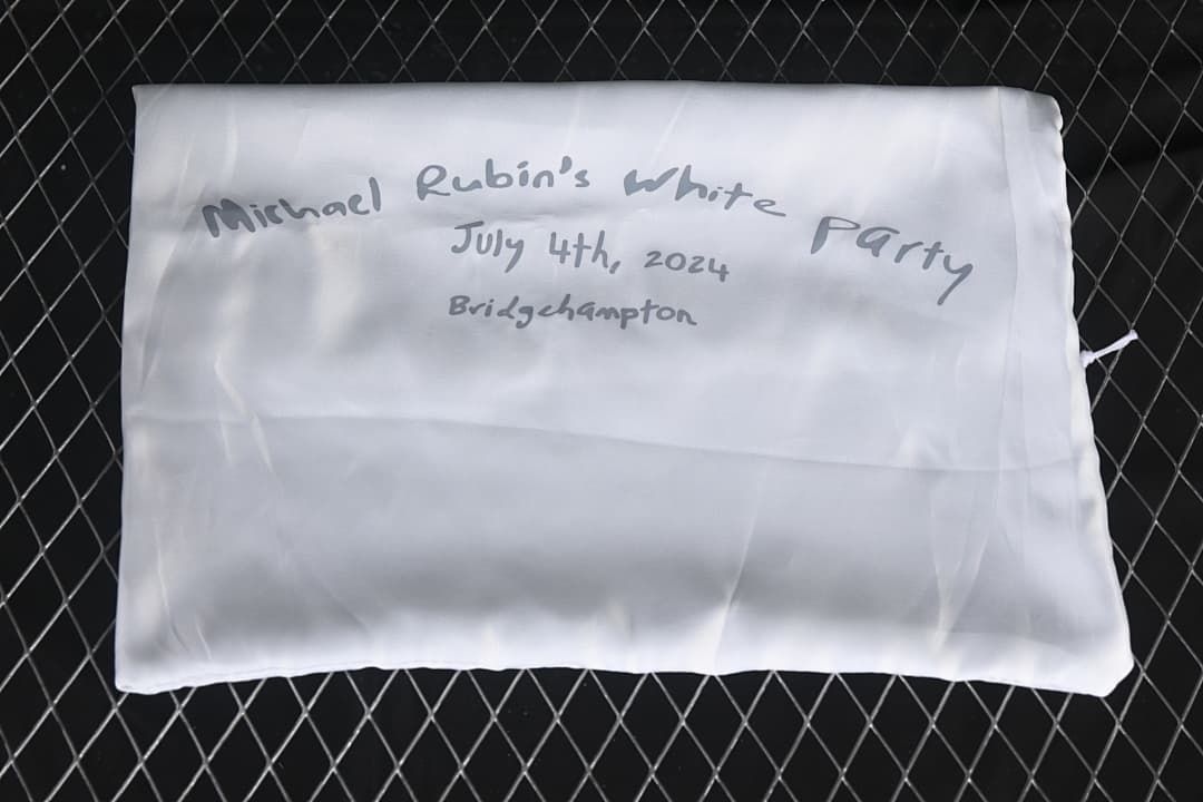 White fabric pouch with handwritten event text