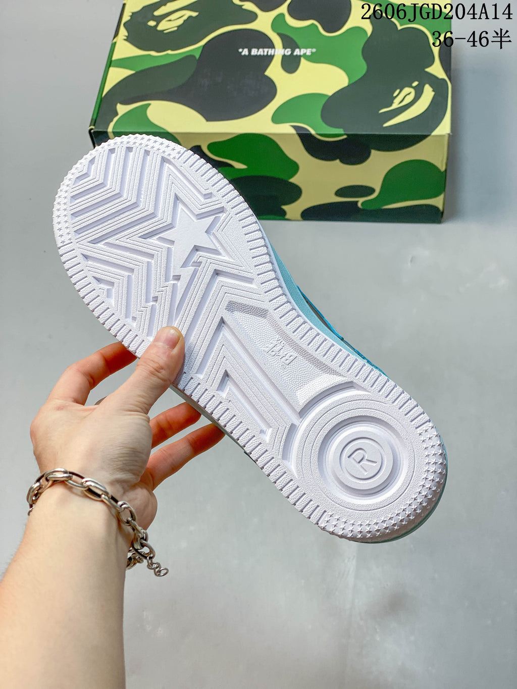 Close-up of the white textured outsole and star-shaped tread on a BAPE STA sneaker