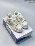 Pair of cream MLB low-top sneakers with cat illustrations, shown on a shoebox