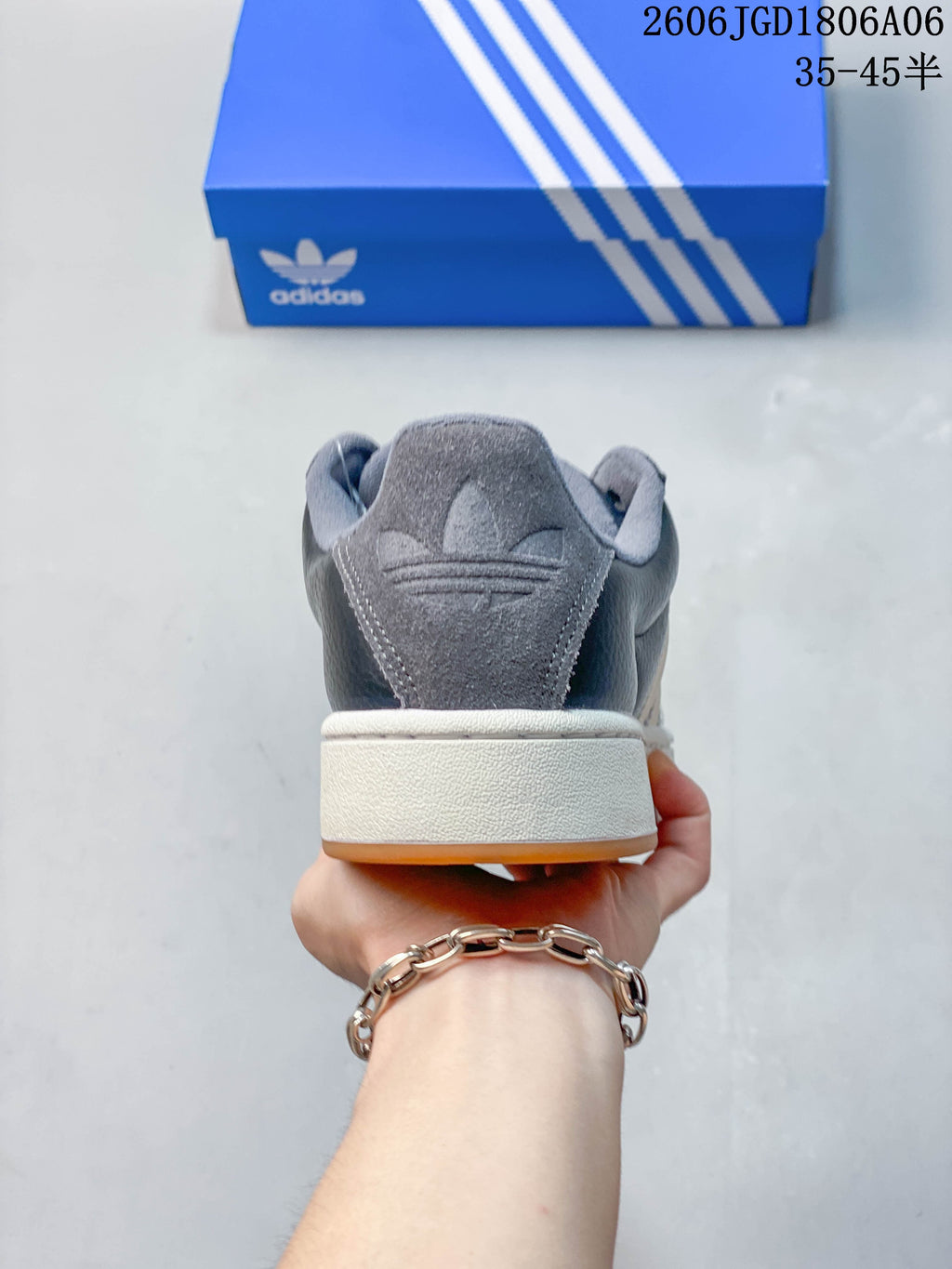 Rear view of the dark grey sneaker showing the heel panel and layered sole.