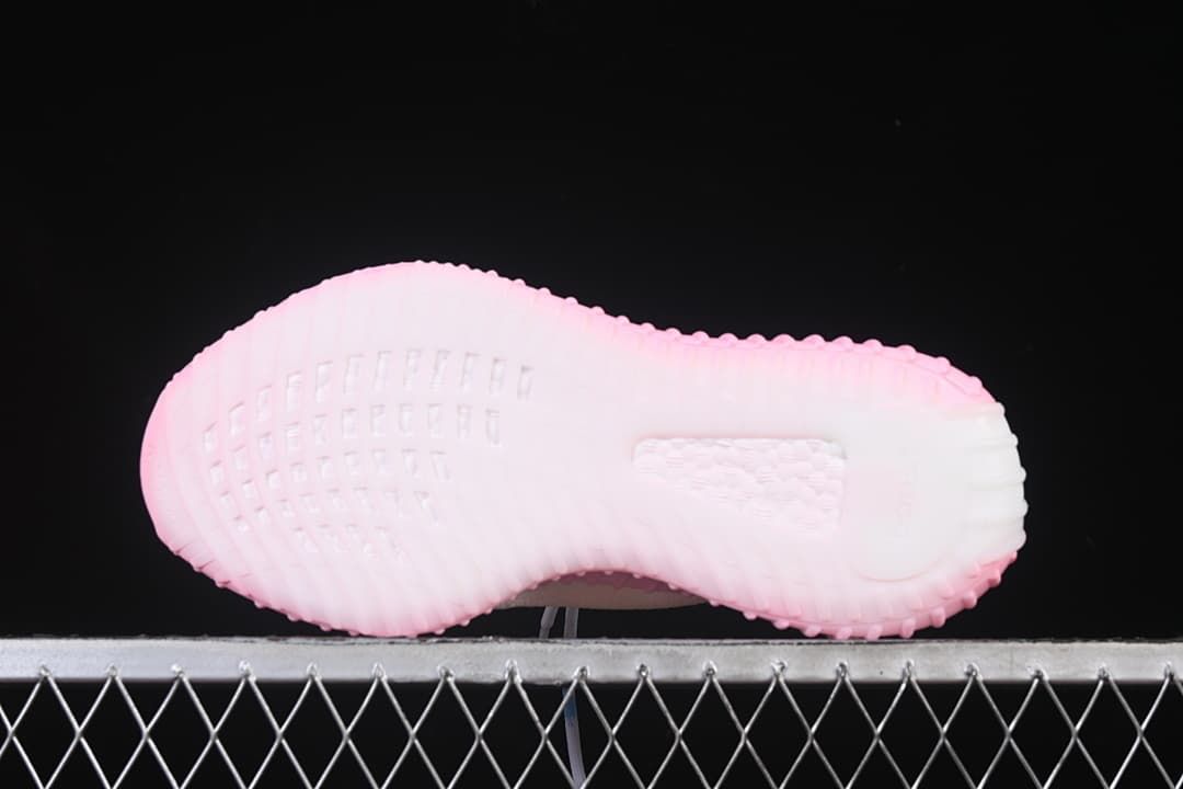 Outsole view showing molded tread and pink coloring.