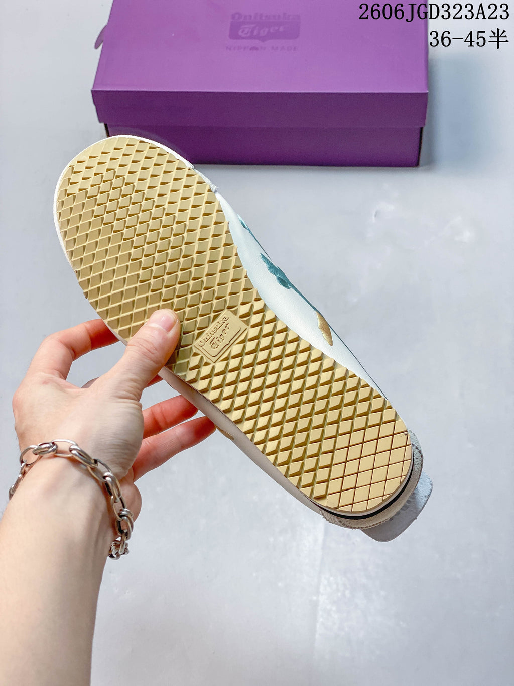 Close-up of the textured outsole on an ivory Onitsuka Tiger Mexico 66 NM sneaker