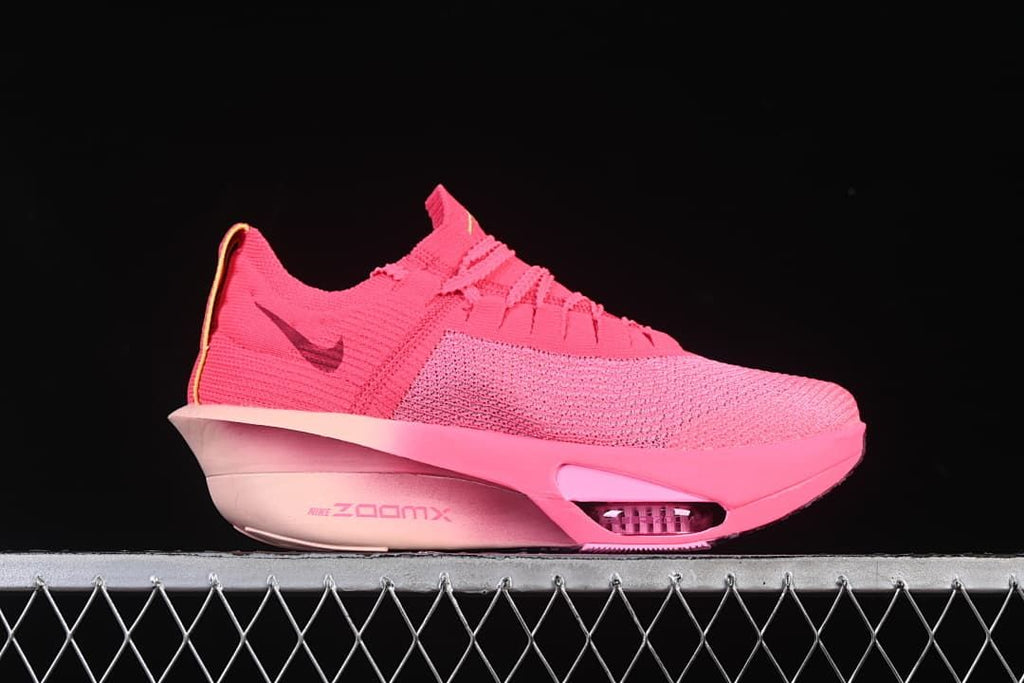 Side profile showing the pink upper and sculpted midsole