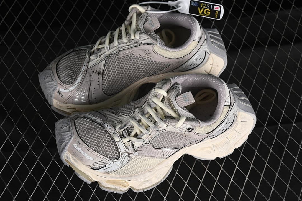 Pair of beige and grey sneakers shown from above
