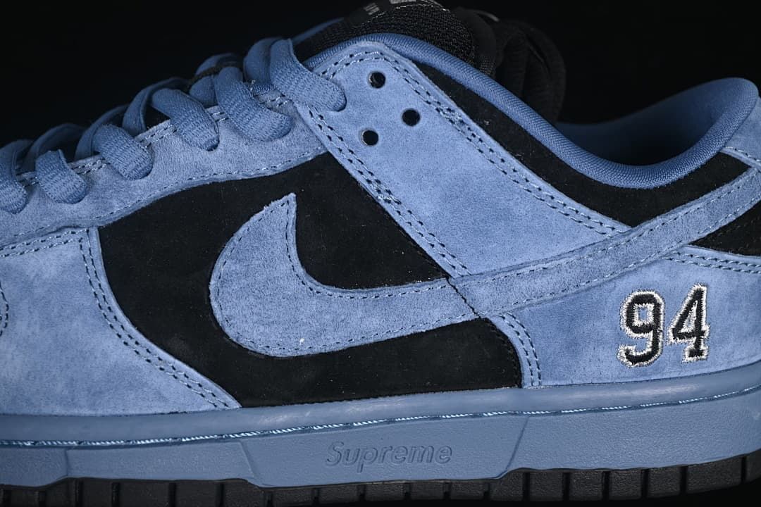 Side detail of the blue and black panels, Swoosh, and embroidered 94
