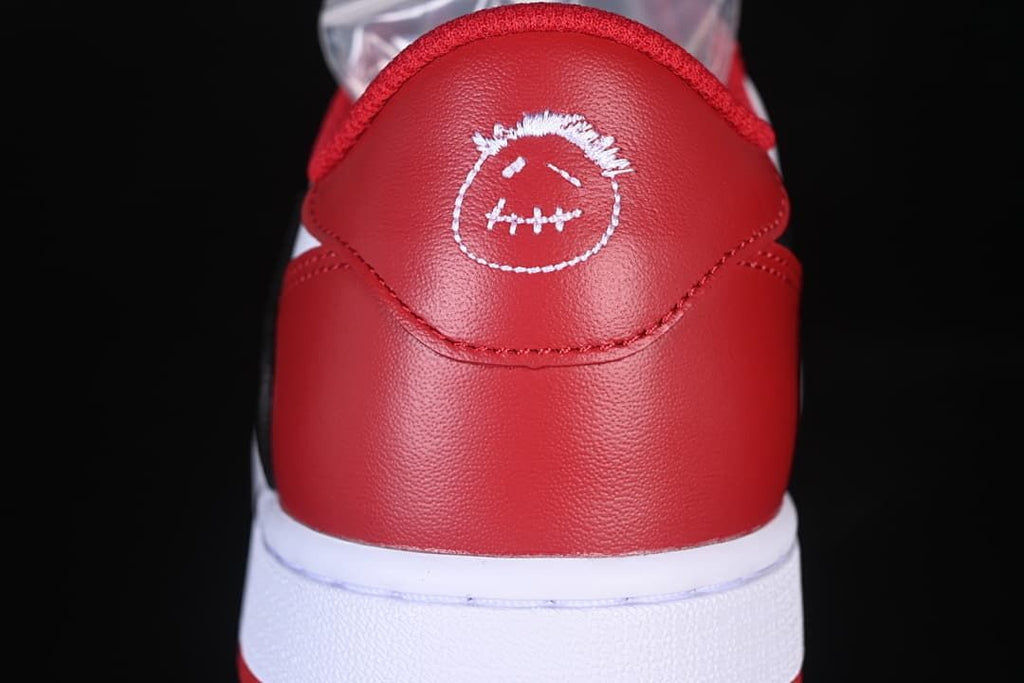 Red heel panel with embroidered face detail