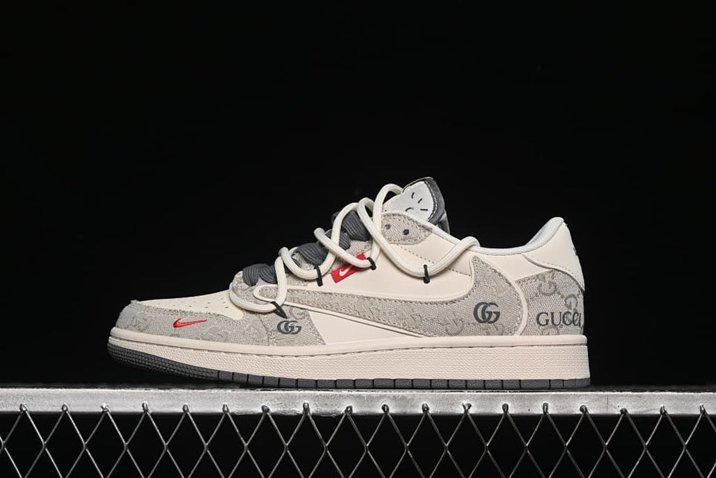 Side view of a light beige and grey patterned low-top sneaker with cream laces and a dark outsole