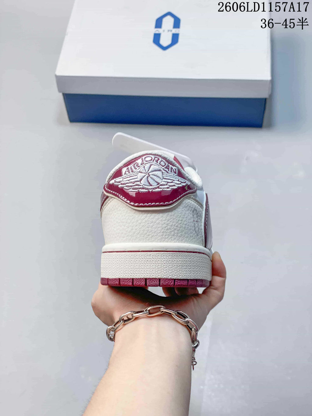 Rear view showing the burgundy heel tab and white upper