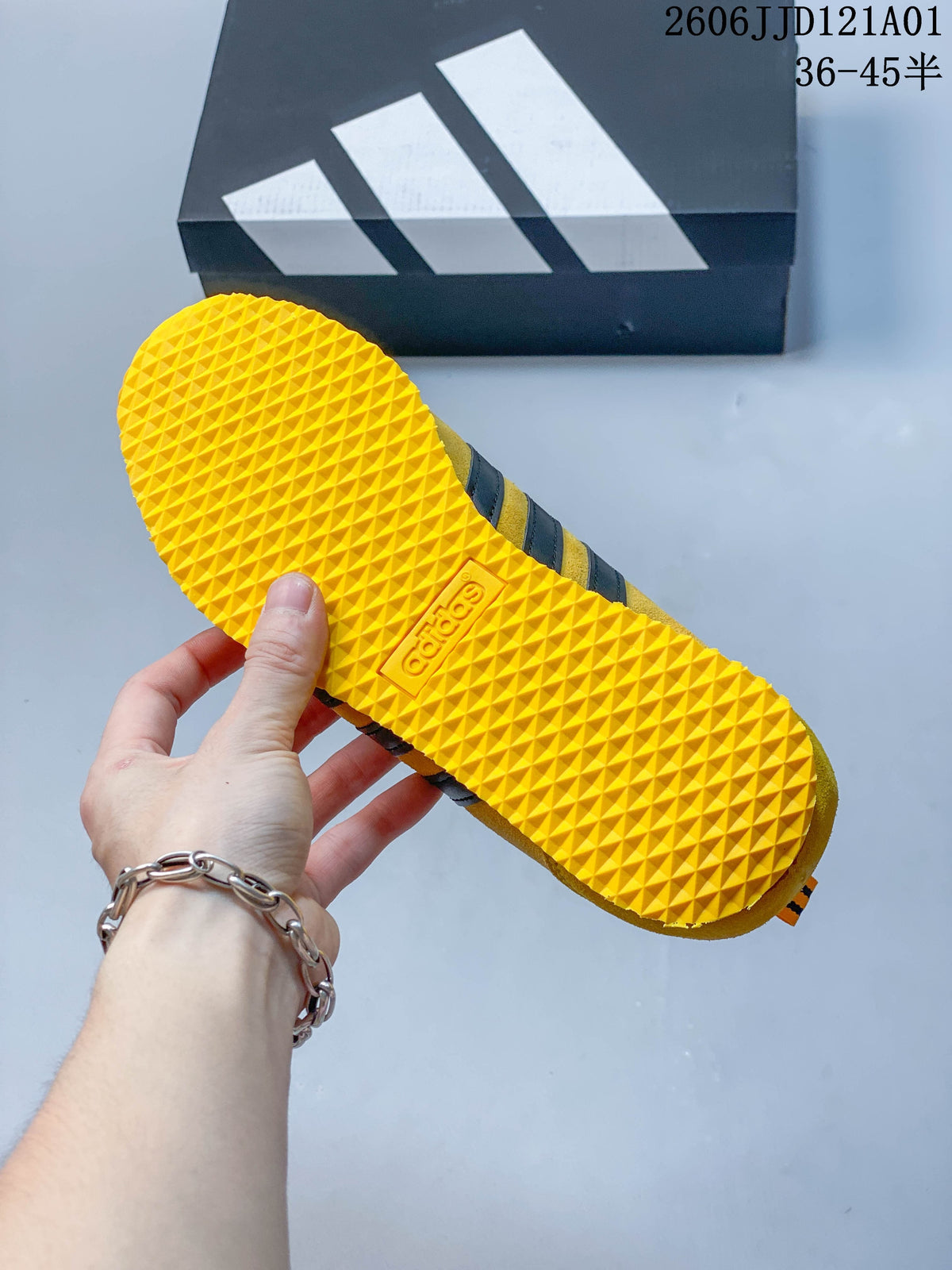 Underside of the yellow sneaker showing its textured outsole