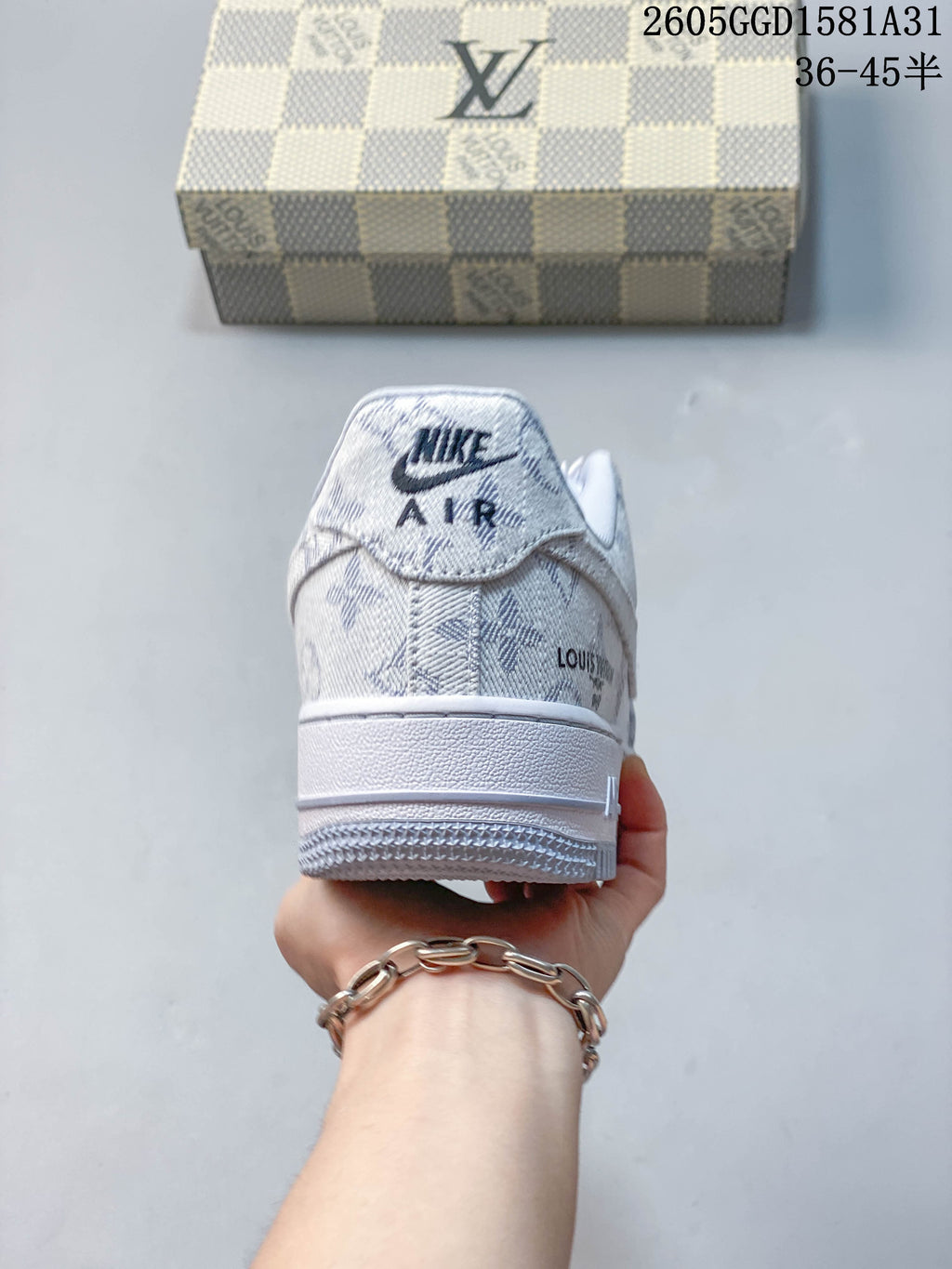 Rear view of a white and grey patterned Nike low-top sneaker