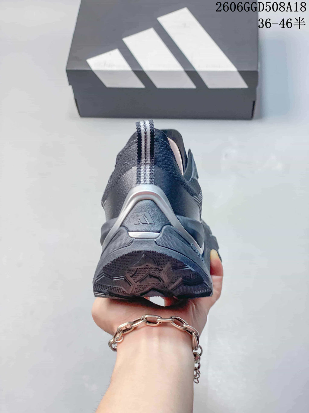 Rear view showing the heel and outsole of a gray Adidas shoe