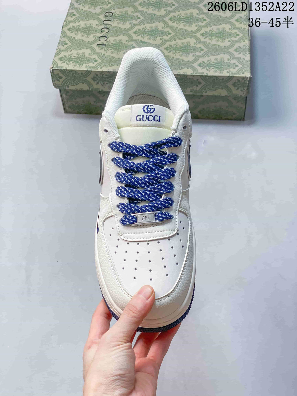 Top view showing perforated toe, blue laces and Gucci tongue branding; image text shows style code 2606LD1352A22 and size range 36–45.5.