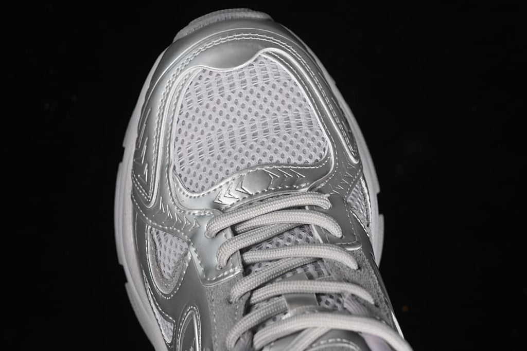 Top-down close-up of the sneaker toe, mesh-style panel, and laces.