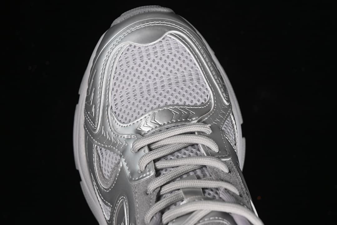 Top-down close-up of the sneaker toe, mesh-style panel, and laces.