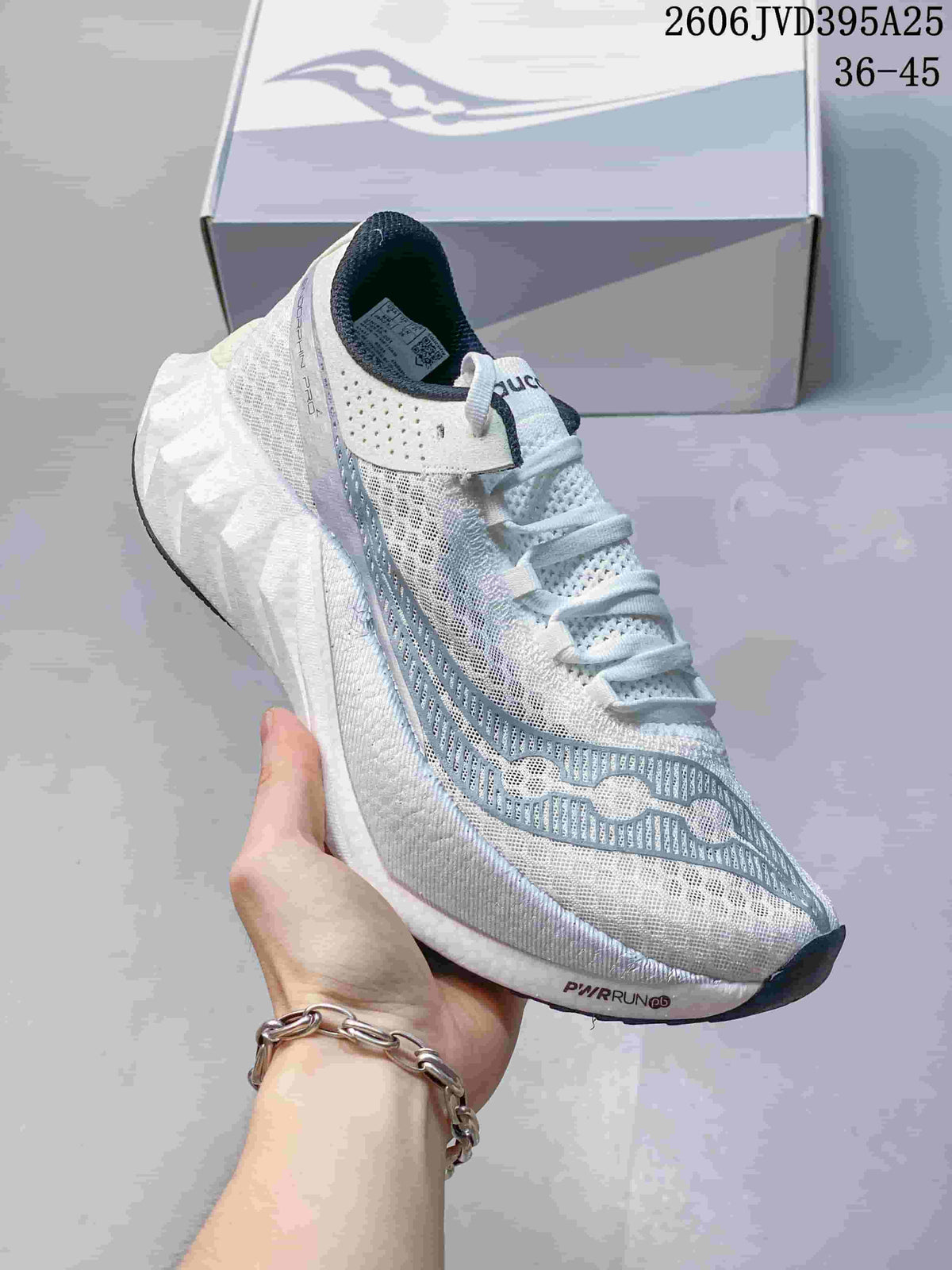 Close-up of a white Saucony Endorphin Speed 5 shoe with blue-gray accents.