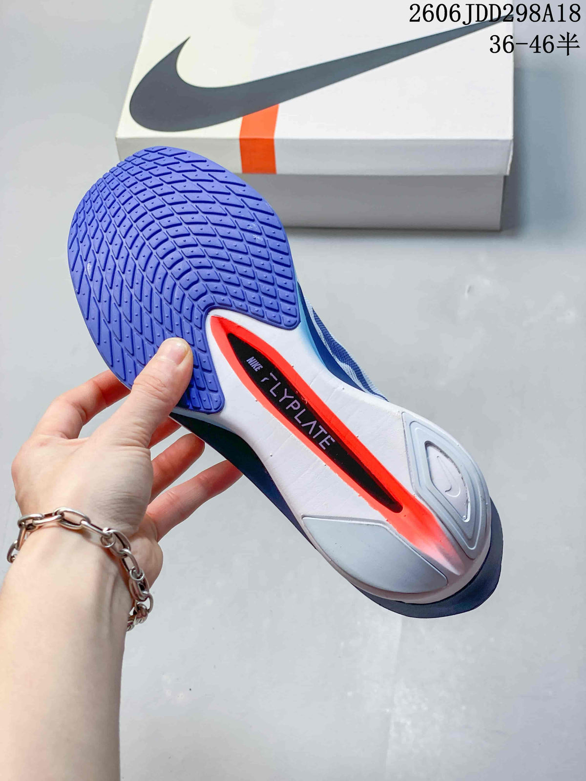 Bottom view showing the blue patterned outsole and central plate area