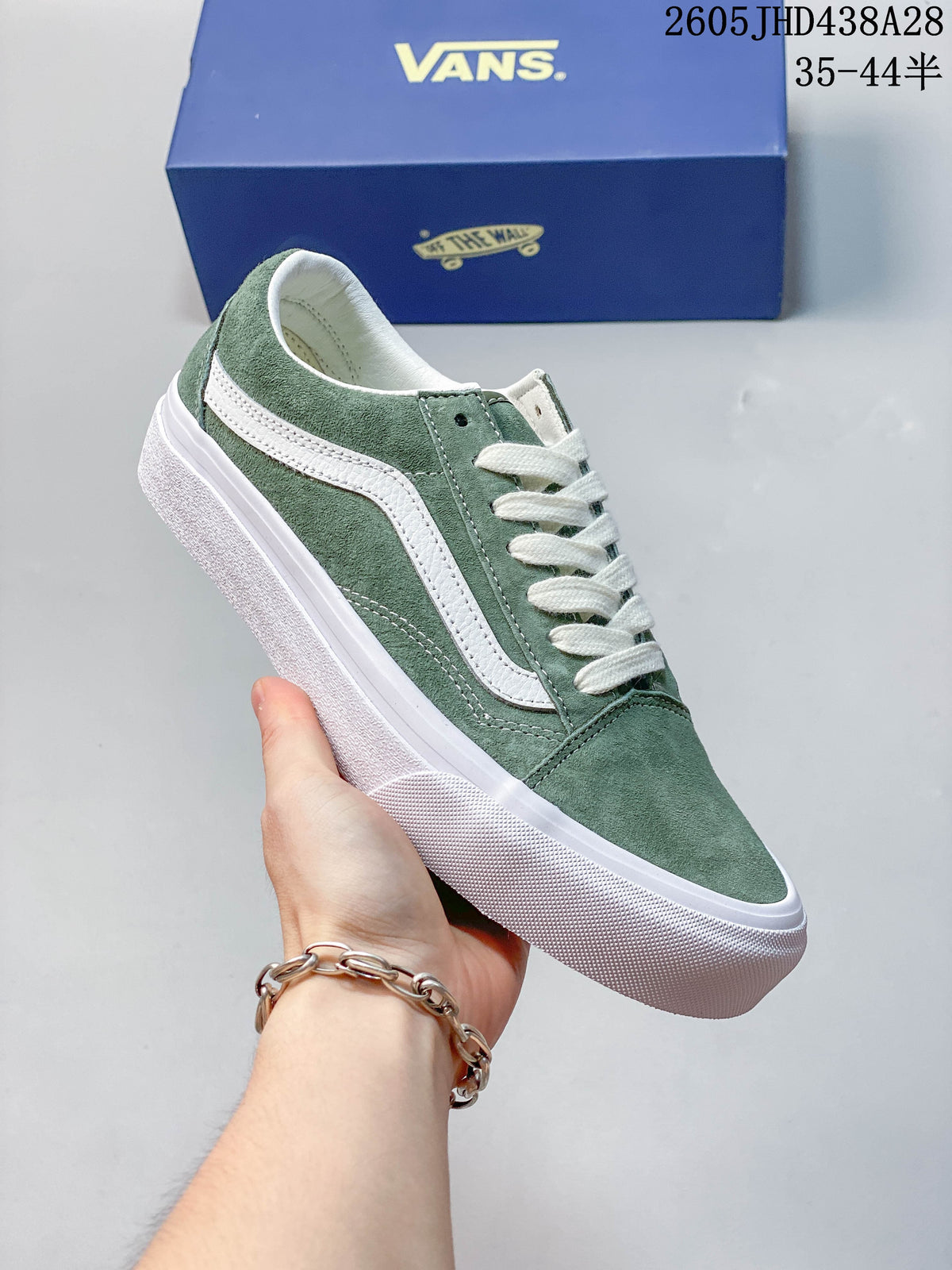 Green low-top sneaker shown from the side, with a white stripe, laces and rubber sole.